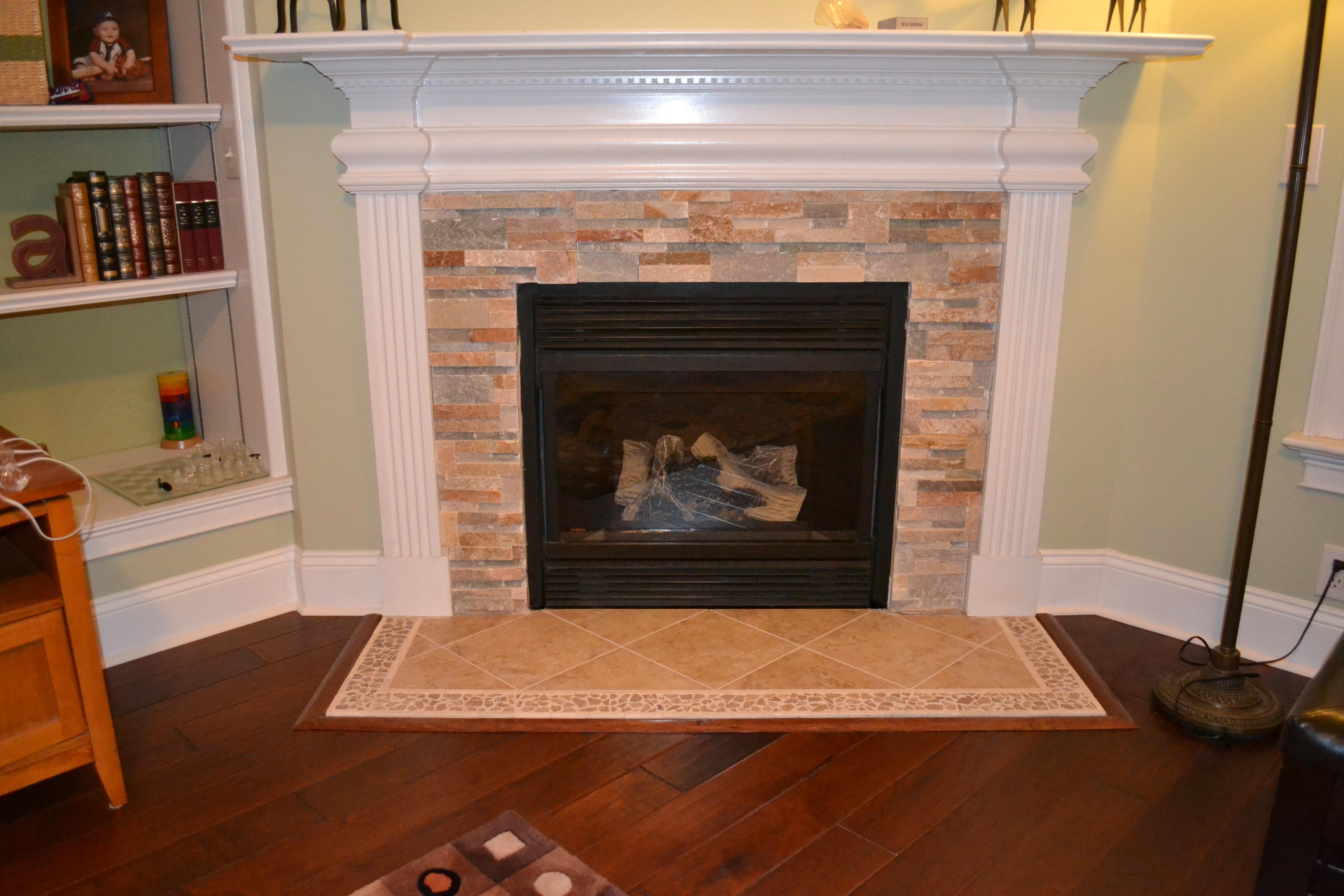 A fireplace facelift with real stackstone and custom tile accent stands out next to 5" handscraped Kupay floor. We work with our customers to make sure all the facets of the project work great together!