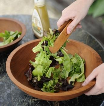 Fresh salad in hand crafted salad bowl