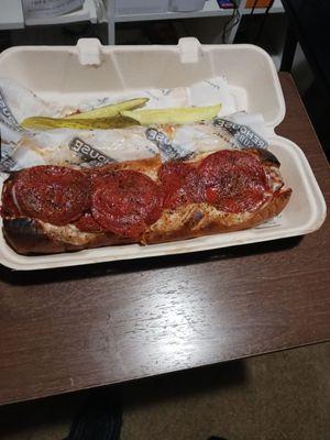 Pepperoni meatballs on white bread with pickle on the side!