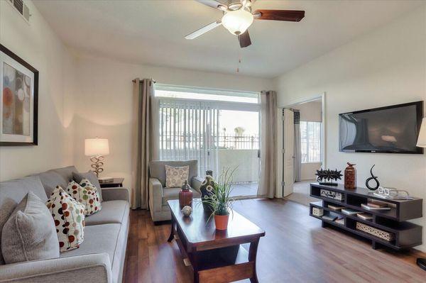 Spacious living room with wood-style vinyl plank flooring and access to patio.