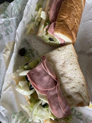 Bread with lettuce and a little slivers of meat.