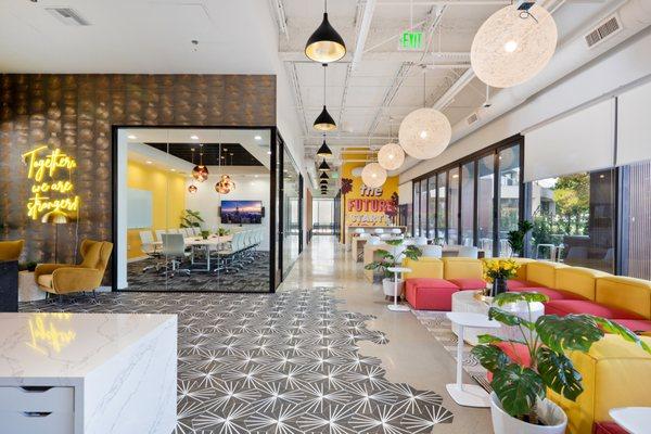 modern and vibrant coworking space with comfortable lounges, desks, and booths to work out of.