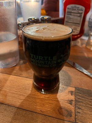 The Com-Bloc black Baltic stout in 12 ounce glass.