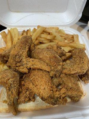 Whole wings seasoned french fries in two slices of bread