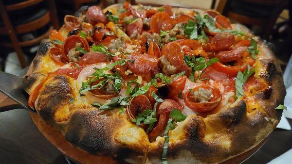 Pizza with pepperoni,  sausage,  tomatoes,  basil, garlic , roasted peppers . Very good.