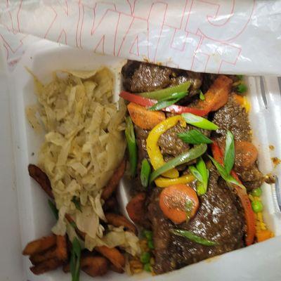 Oxtails with sweet potato fries and cabbage