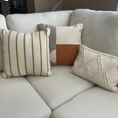 The two flanking cushions were found at Sweet Tea Living