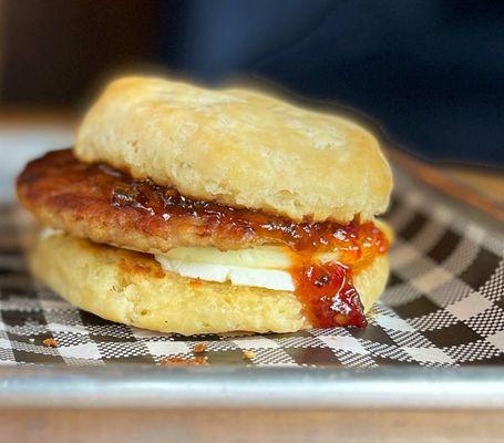 Jamtastic breakfast sandwich. Fried egg, cream cheese, habanero bacon jam and sausage patty on a biscui.