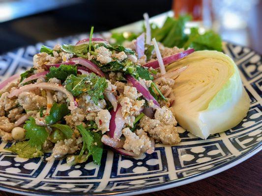 SL4. Pork Larb. $9. Spicy Thai pork salad. Ground pork, chili, roasted rice powder, onion, cilantro, scallion, Thai chili-lime dressing.