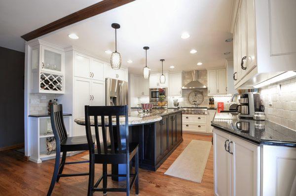 Nice concept with a black island with the upper and lower cabinets painted white