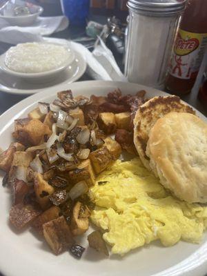 Country breakfast with one scrambled egg.  Grits and biscuit.