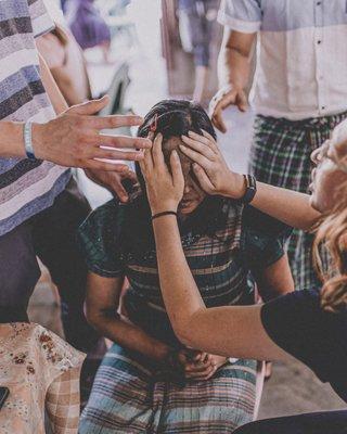 YWAM Orlando Students praying for woman in the Dominican Republic