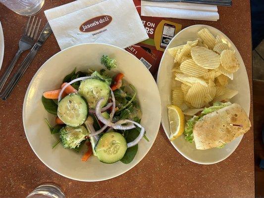 Interior: salad from the salad bar, chips alongside salmon sandwich