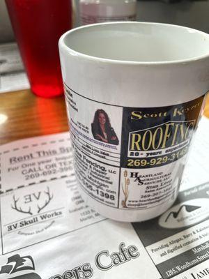 Local ads decorate the coffee mugs and table mats.