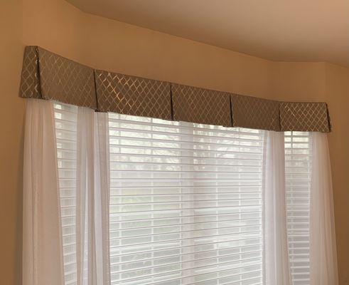 Box pleat valance, sheer side panels, and wood blinds.