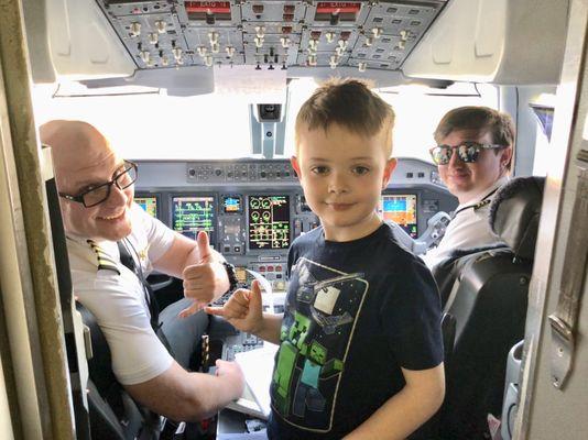 The pilot, co-pilot, & Noah in the cockpit of our DL5789 flight.