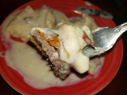 One delicious bite of chicken fried steak and gravy!