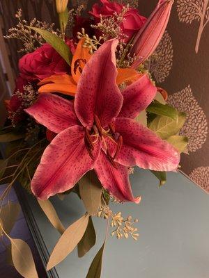 Birthday arrangement. Huge stargazer lily with gorgeous roses.