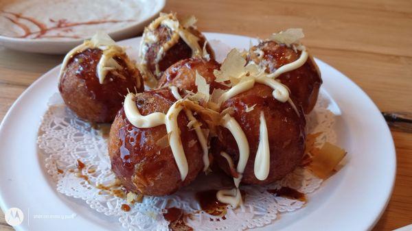 Takoyaki (たこ焼き or 蛸焼) is a ball-shaped Japanese snack filled with octopus.