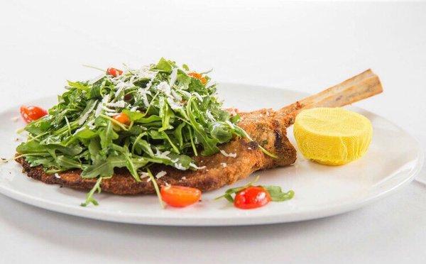 Veal chop parmigiana with arugula