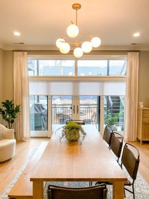 Floor to ceiling drapery and roller shades in dining room