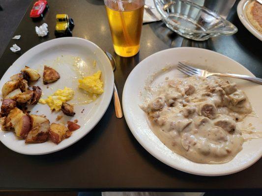 Sausage and biscuits with home fries, eggs, toast