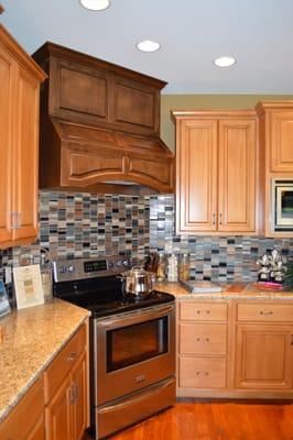 Custom Cabinets & range hood offset with a beautiful tile backsplash