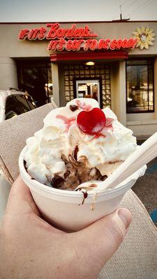 Chocolate nutty sundae with whipped cream and cherry (made with Moose Tracks ice cream). Wet walnuts and hot fudge sauce