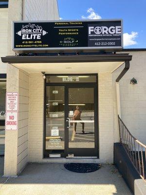 Go through this front door & all the way down the stairs to find a gym space