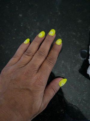 Yellow gel polish with a dainty white daisy and clear rhinestone in the center