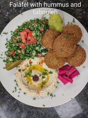 a blend of garbanzo beans and parsley , deep fried .served with hummus tabouleh and tahini sauce .