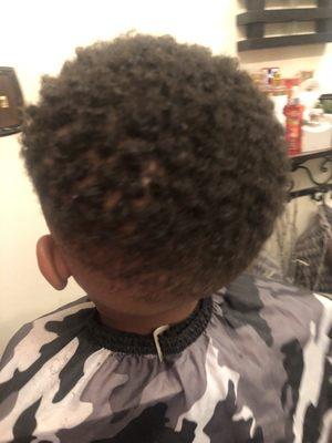 Boy's hair cut with twists