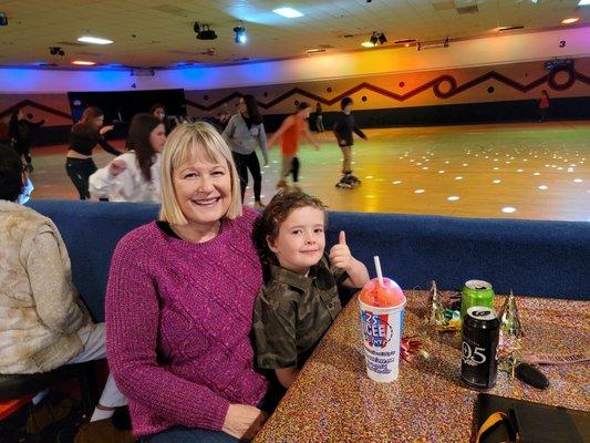 My grandson and me with rink in background