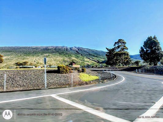 Photo taken from Saddle Road, passing Gilbert Kahele Recreation Area with Mauna Kea in the background.