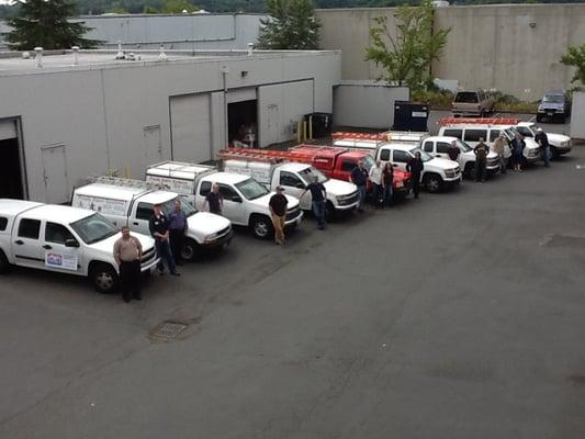 Our team standing near Froula's fleet of trucks.