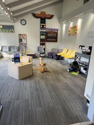 Spacious waiting room with toys, books, and natural light.