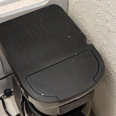 Debris fell through the vent onto the coffee pot and counter in the kitchen area.