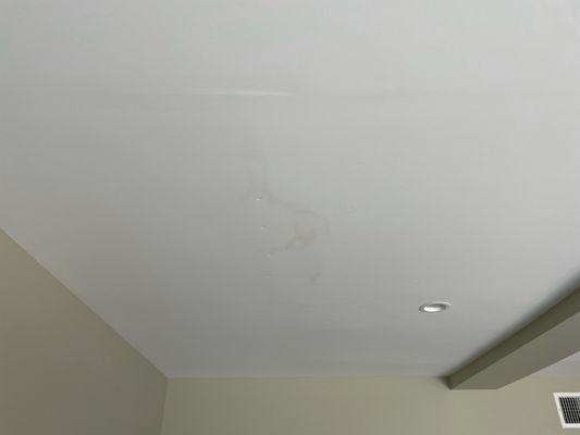 Water damage in the ceiling from the bath tub above.