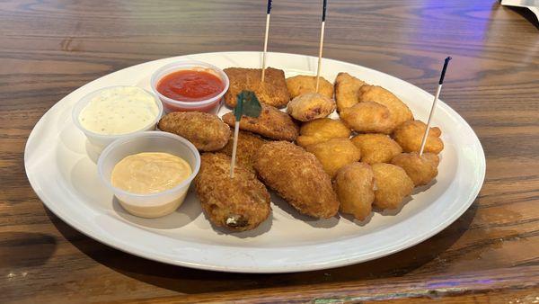 The sampler containing fried ravioli, fried mac & cheese, bites, corn, fritters, and delicious jalapeño poppers