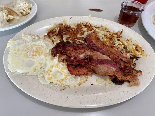 Two fresh eggs with bacon, hash browns, and 1 side (I got biscuits and gravy)