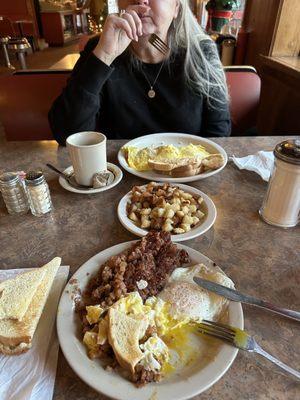 Corn beef hash and eggs, home fries, ham and cheese omelette.