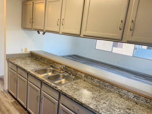 Kitchen After - New Sink & Fixtures, Countertop, Flooring, and Refinished Cabinets