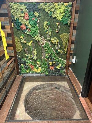 A stunning blend of nature and history--lush greenery surrounds the real in-store wishing well, adding a unique touch to the ambiance.