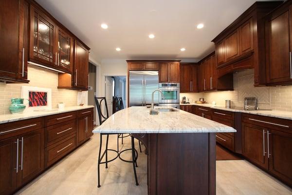 Luxury kitchen remodel with marble countertops, stainless appliances, and cherry cabinets