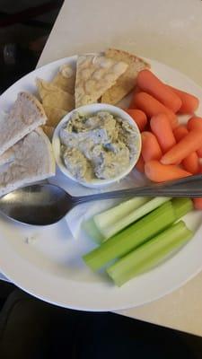 Hummus wit pita bread, celery and carrots.