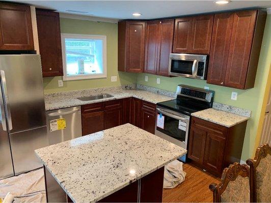 Colonial white granite with cherry cabinets in Brookeville, Maryland. Call today for your estimates 240-330-9008 Carlos