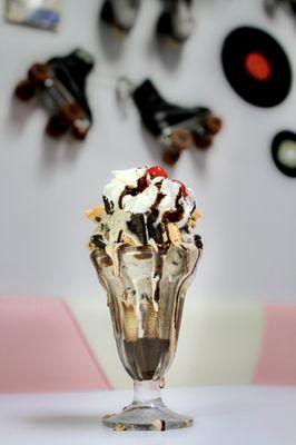 The Cookie Monster: Our homemade cookies & cream ice cream topped with whipped cream, Oreos, chocolate chip cookies & chocolate drizzle.