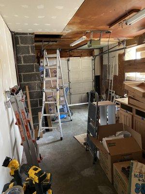 Before. Brown sheetrock, paneling, and garage door.  (We moved our belongings out before demo.)