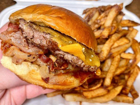 Cheddar Bacon Burger - 1/4lb beef patty, cheddar, applewood smoked bacon, grilled onions, bbq sauce on a potato bun + fries