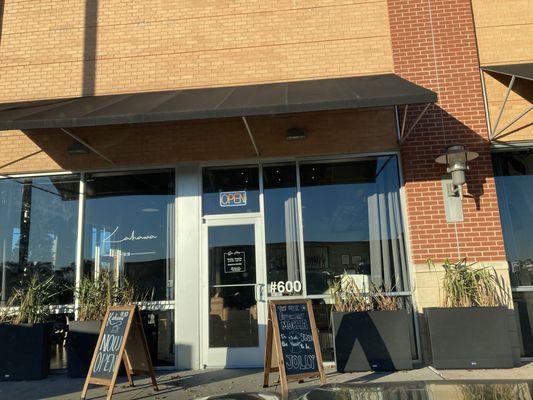 Exterior of coffee shop with sandwich board signs.